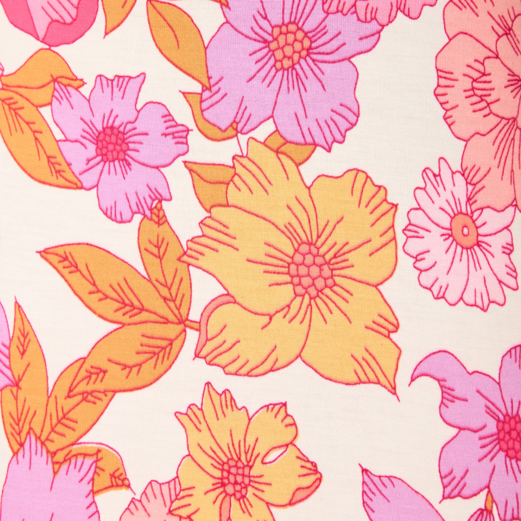 Close-up of a bright floral print on soft ivory fabric, featuring layered flowers in pink, orange, and purple with bold line detailing.