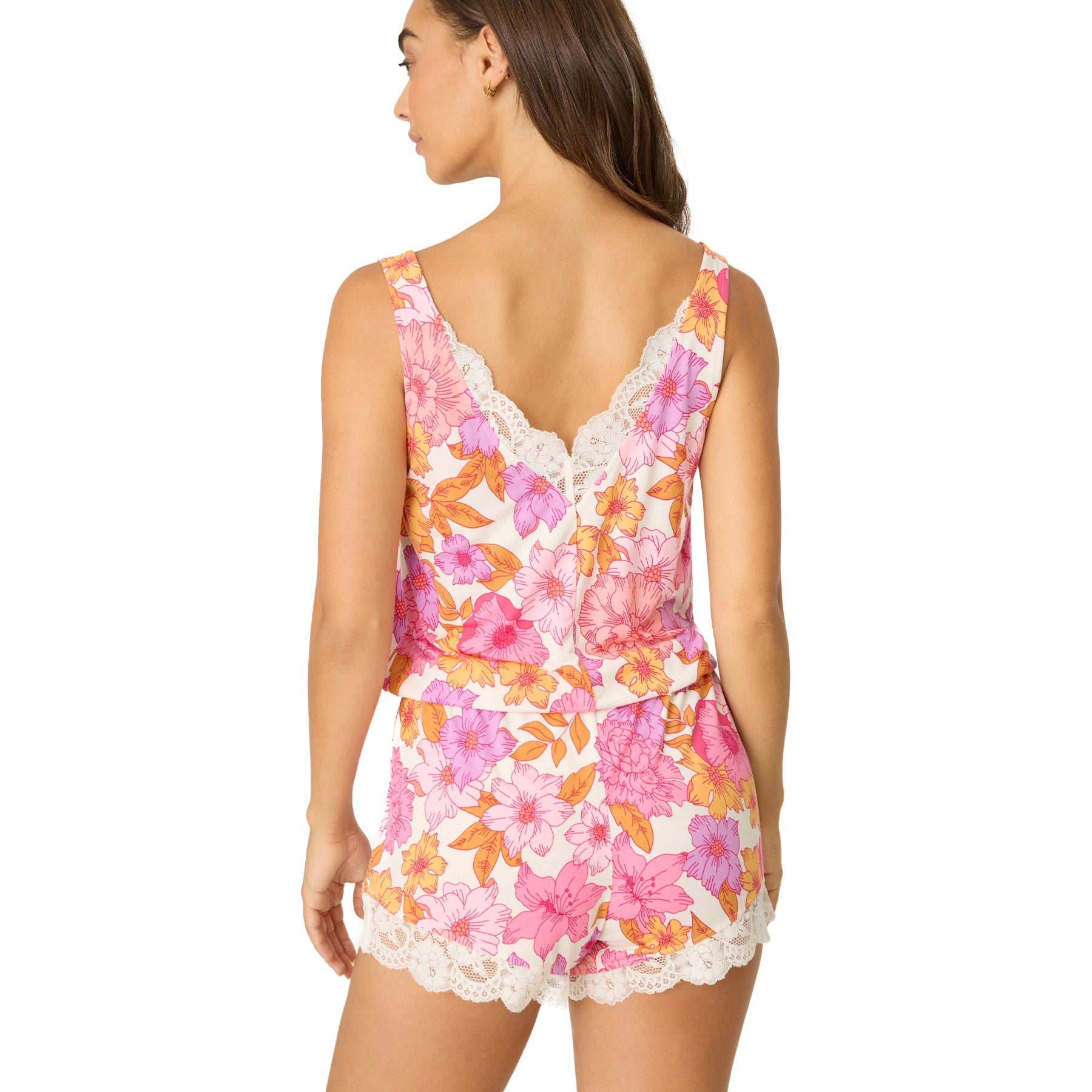 Woman shown from the back wearing a vibrant floral cami and shorts set, featuring ivory lace trim at the back neckline and short hems.