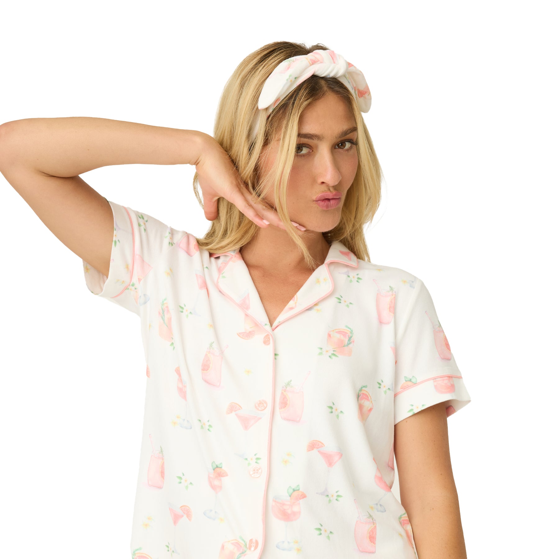 Close-up of ivory pyjama set fabric featuring pink cocktail and citrus motif print
