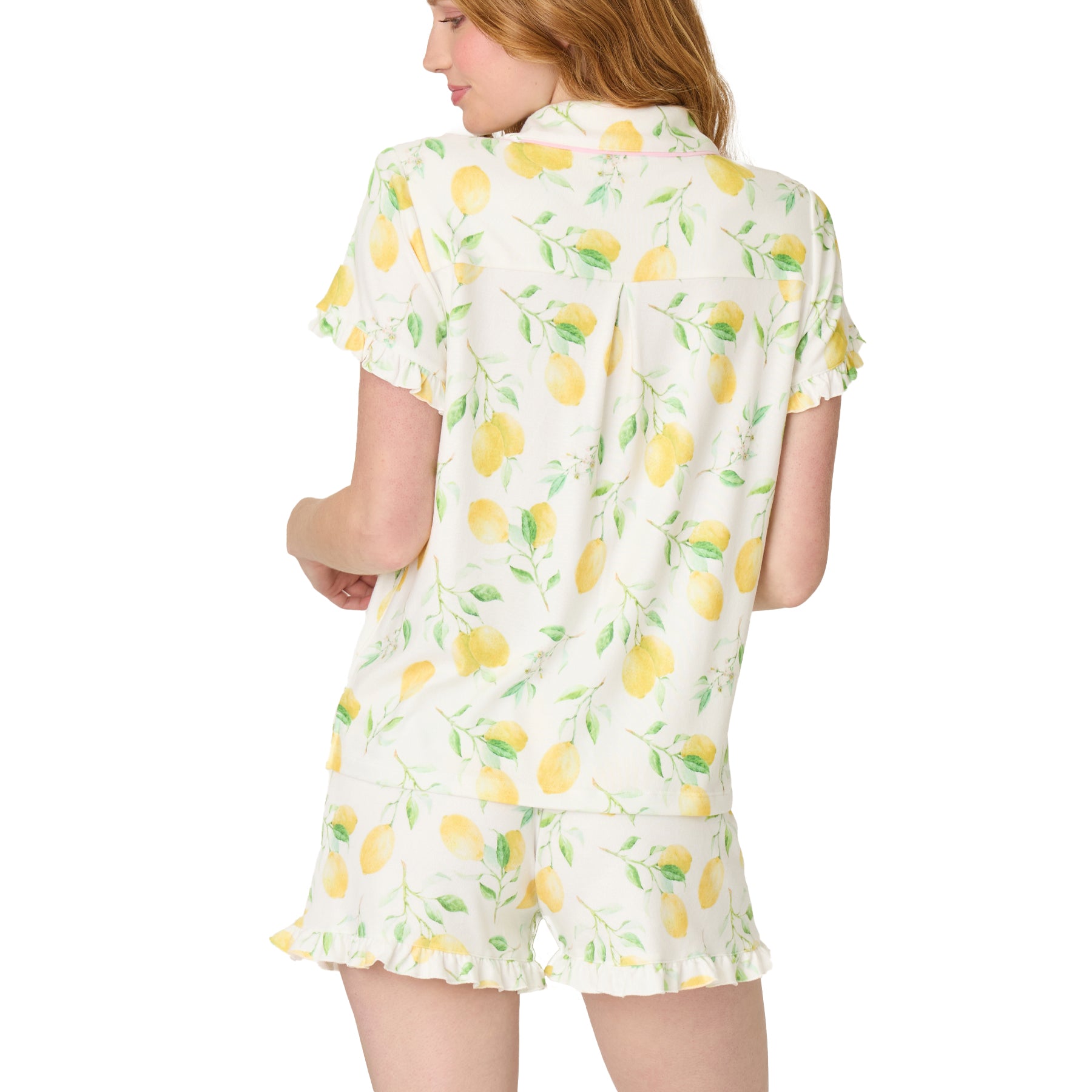 Back view of ivory lemon print pyjama set with short sleeves, ruffle hem shorts, and soft drape fabric