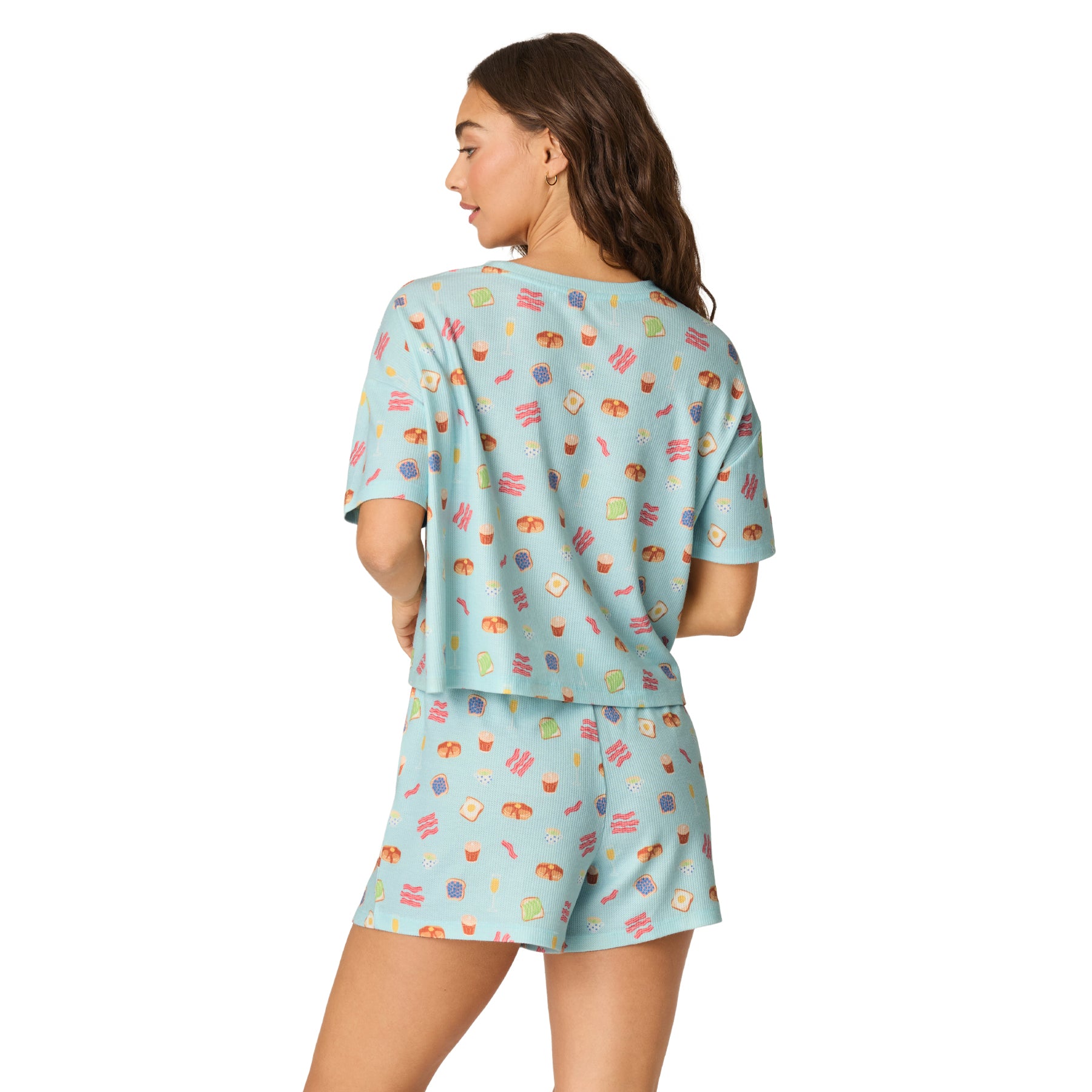 Back view of women's light blue breakfast print waffle knit pajama set with relaxed short sleeve top and matching sleep shorts.