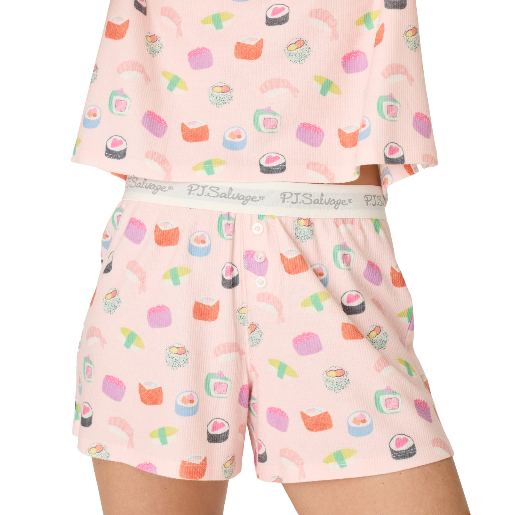 Detail of women's pink sushi print pajama shorts with PJ Salvage logo waistband, decorative button fly, and soft waffle knit fabric.