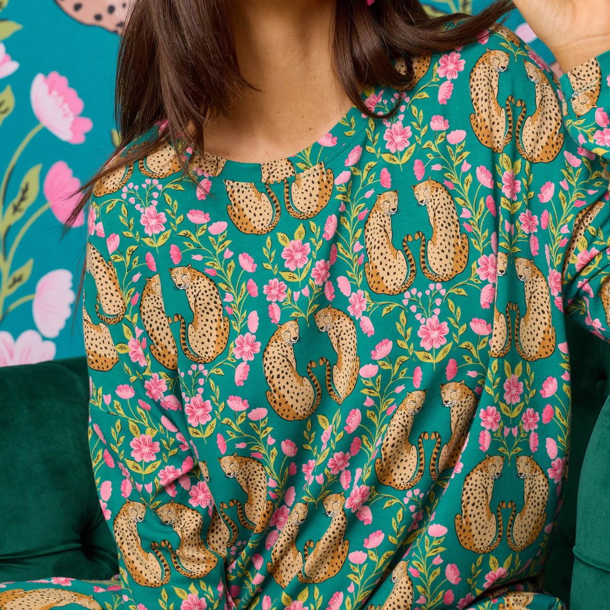 Close-up of teal pajama top featuring a playful cheetah and pink floral print.