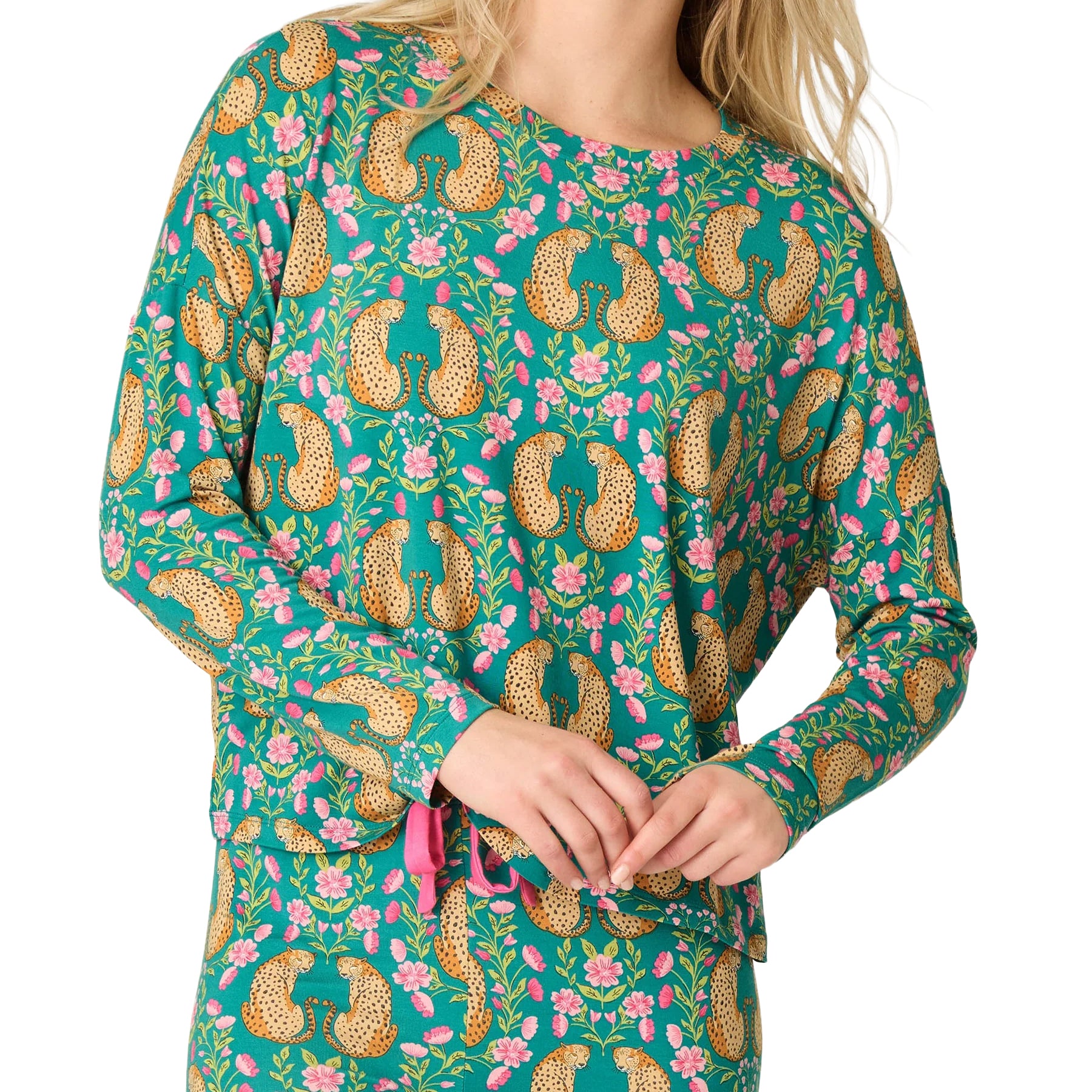 Close-up of teal pajama set featuring golden cheetahs, pink flowers and a contrasting pink waist drawstring.