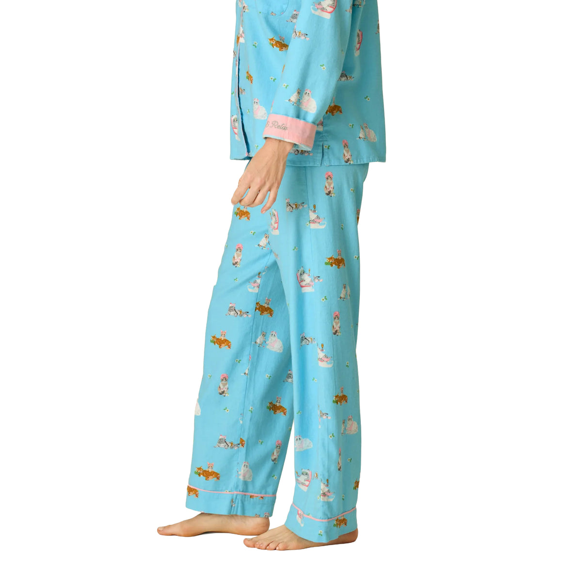 Side view of PJ Salvage Paws & Relax flannel pyjama set featuring blue cat print fabric, pink sleeve cuffs and matching long pants.