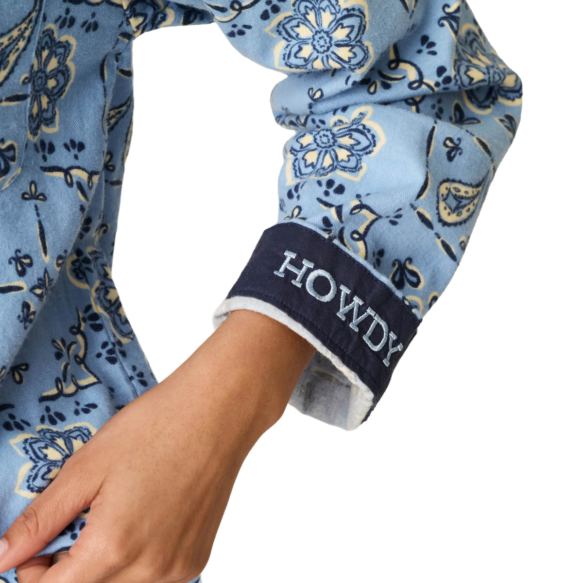 Close-up of PJ Salvage Howdy flannel pyjama sleeve featuring navy cuff with embroidered HOWDY lettering.