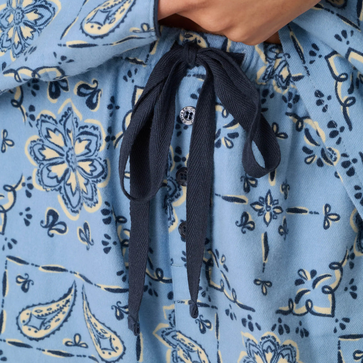 Close-up of PJ Salvage Howdy flannel pyjama pants featuring navy drawstring waistband and blue floral paisley print.