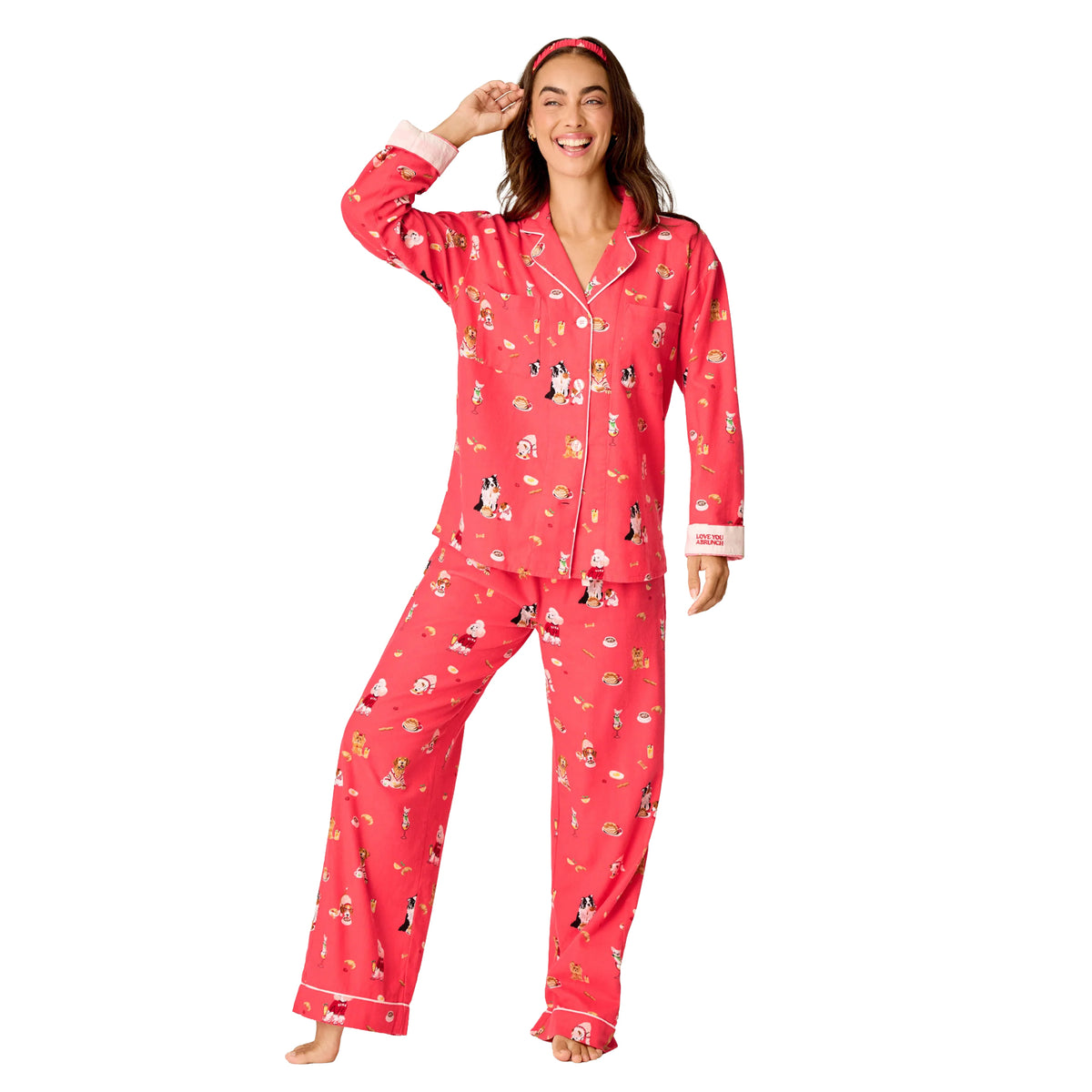 Model wearing PJ Salvage Brunch Pups flannel pyjama set in Coral with playful dog and breakfast print, front view.