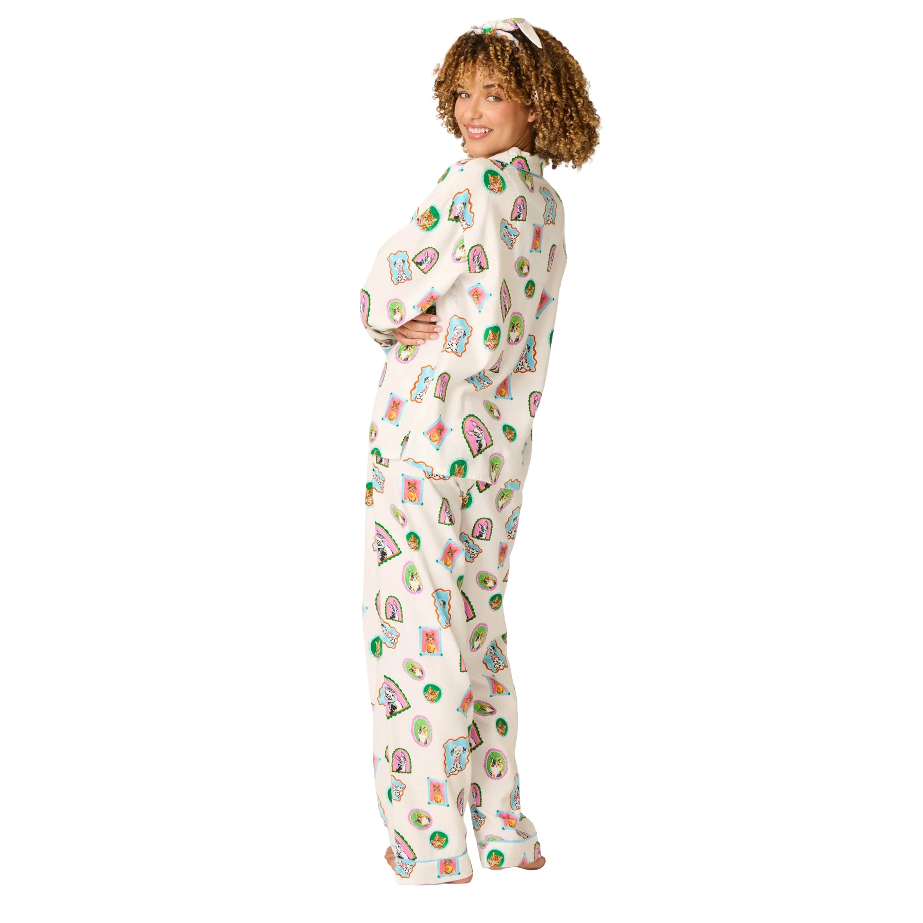 Back and side view of cream dog and cat print pajama set with relaxed button-up top and matching pants.