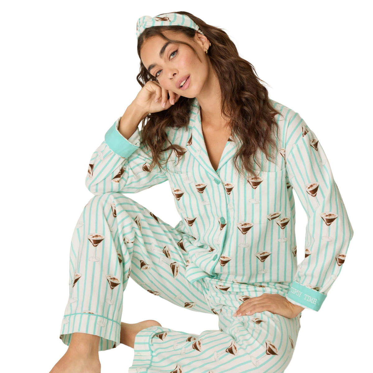 Model wearing PJ Salvage Tipsy Time button-down pyjama top and matching pants, seated front view.