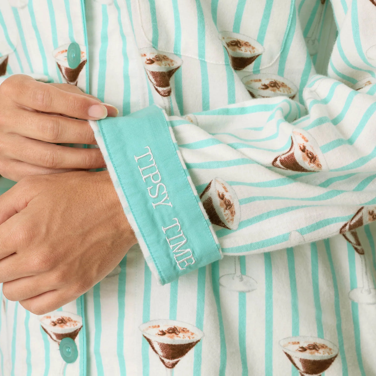 Close-up of PJ Salvage Tipsy Time pyjama top featuring mint cuff with embroidered Tipsy Time lettering and cocktail print.