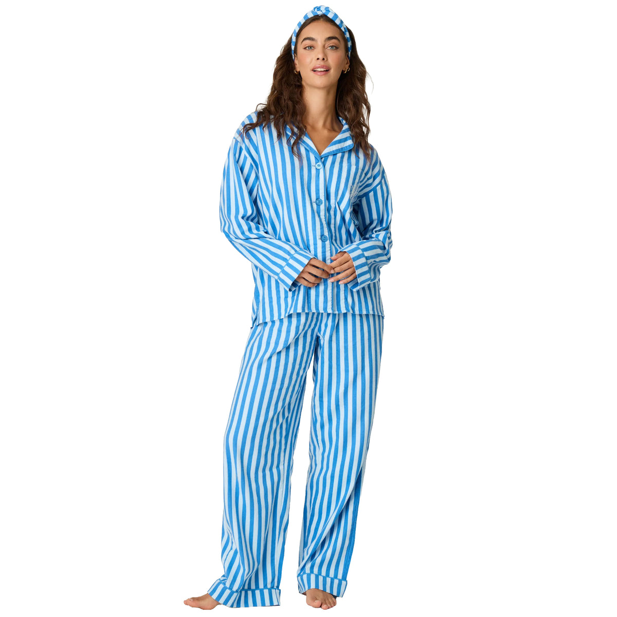 Model wearing blue and white striped flannel pajamas with relaxed-fit pants and button-up shirt, front view.