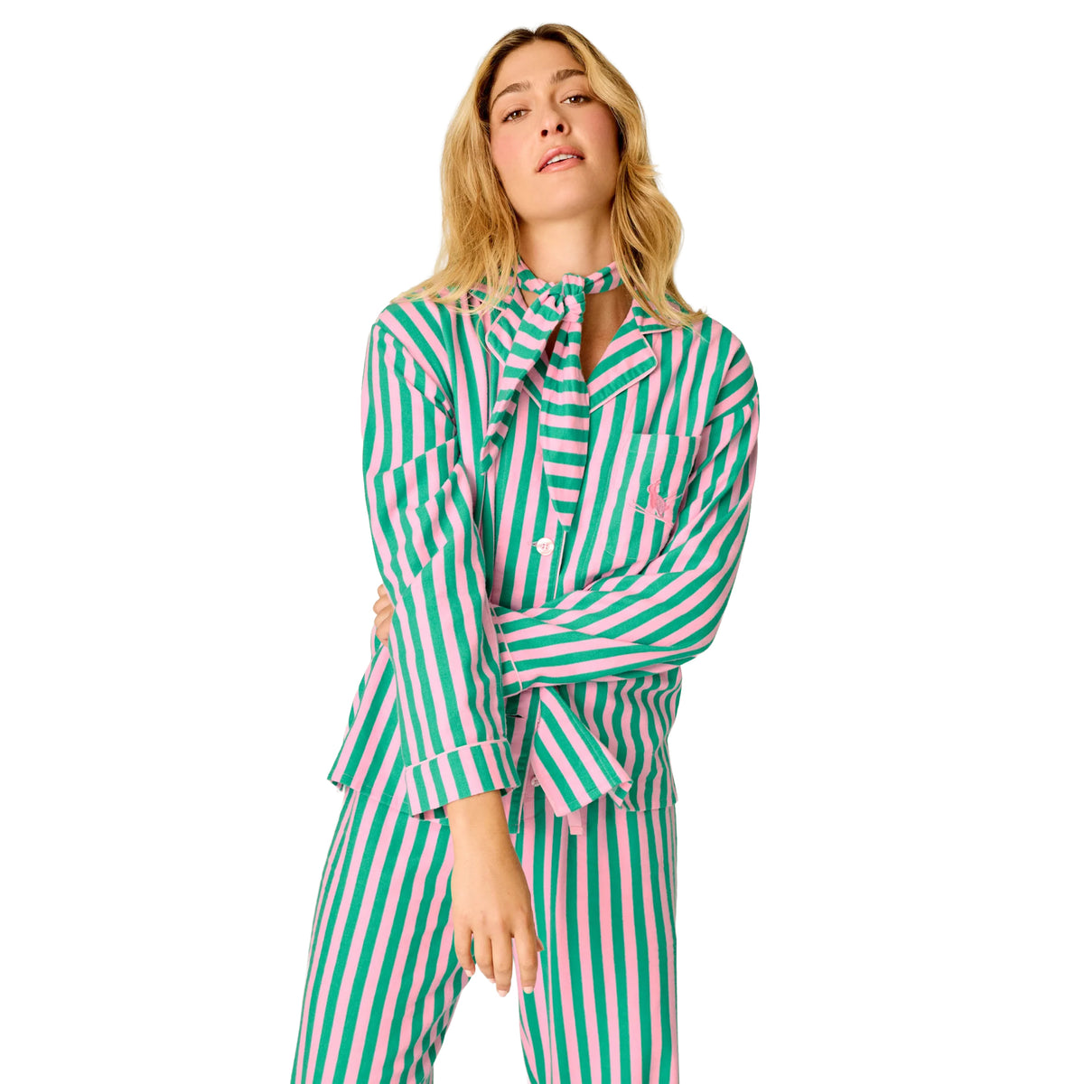 Model wearing pink and green striped flannel pajamas with long sleeves, chest pocket and matching neck scarf, front view.