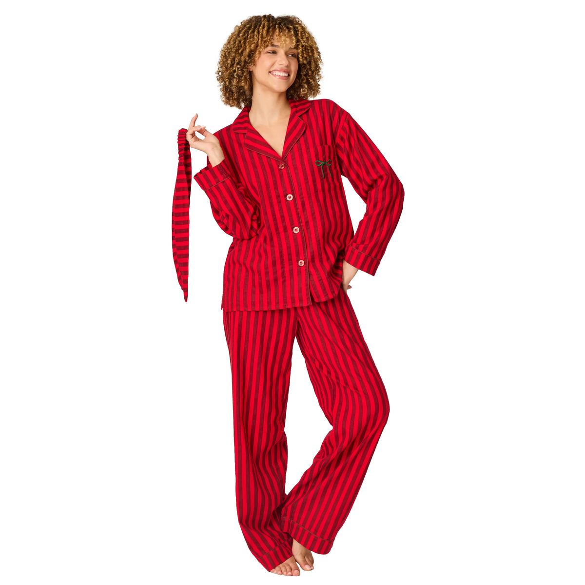 Model wearing red and burgundy striped flannel pajamas with button-up top and full-length pants, front view.