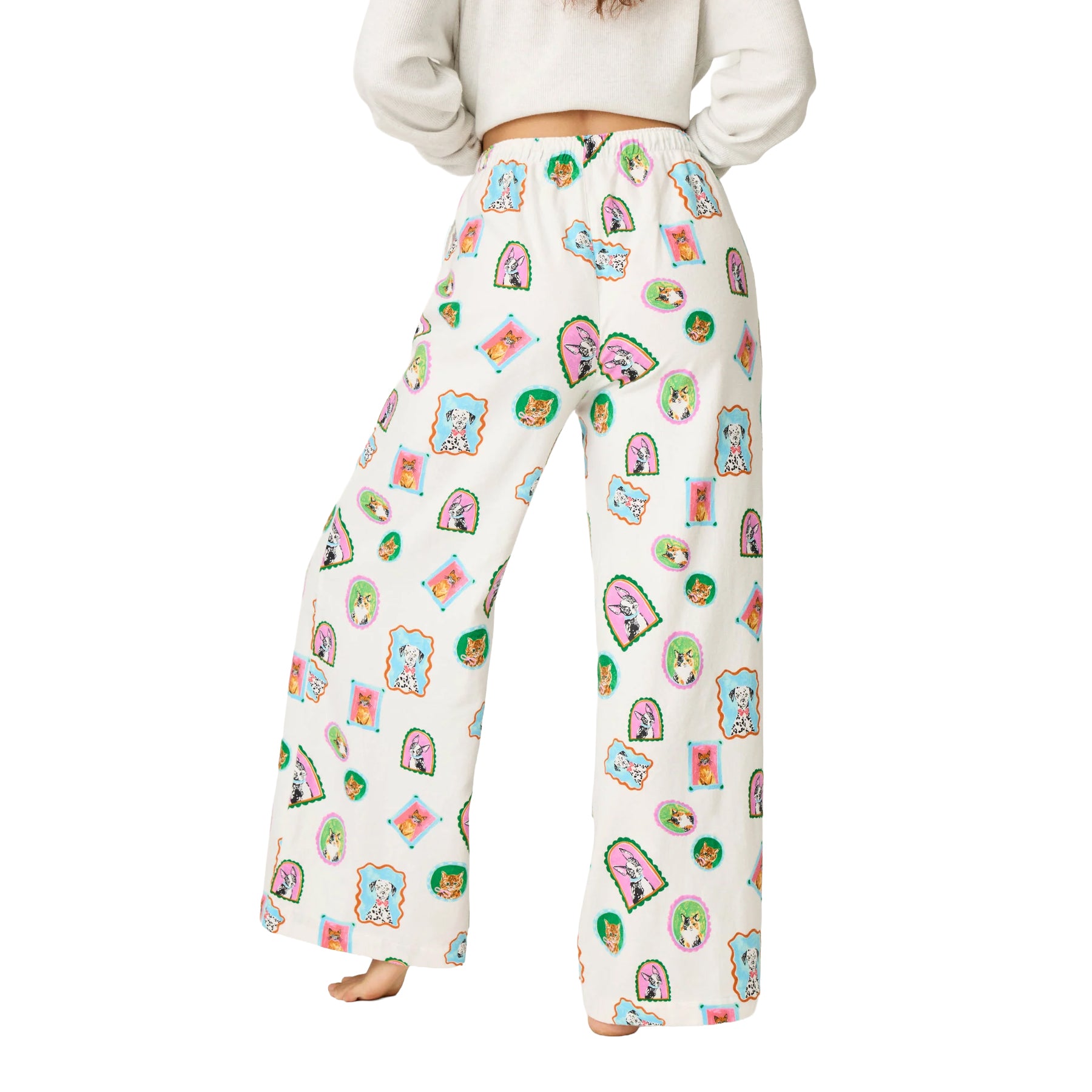 Back view of cream wide-leg pajama pants with an all-over colorful dog and cat portrait print and elastic waistband.