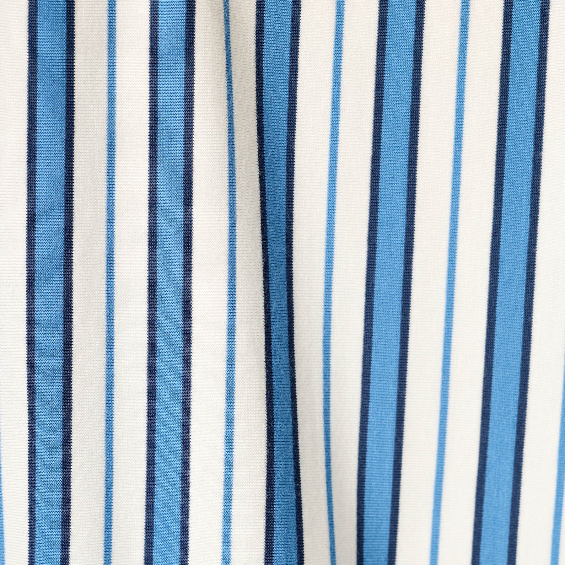 Close-up of soft blue, navy and white striped fabric.