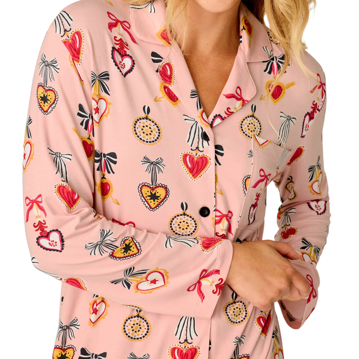Close-up of PJ Salvage Hearts pink sleepshirt featuring notched collar, black buttons and colourful heart and bow print.