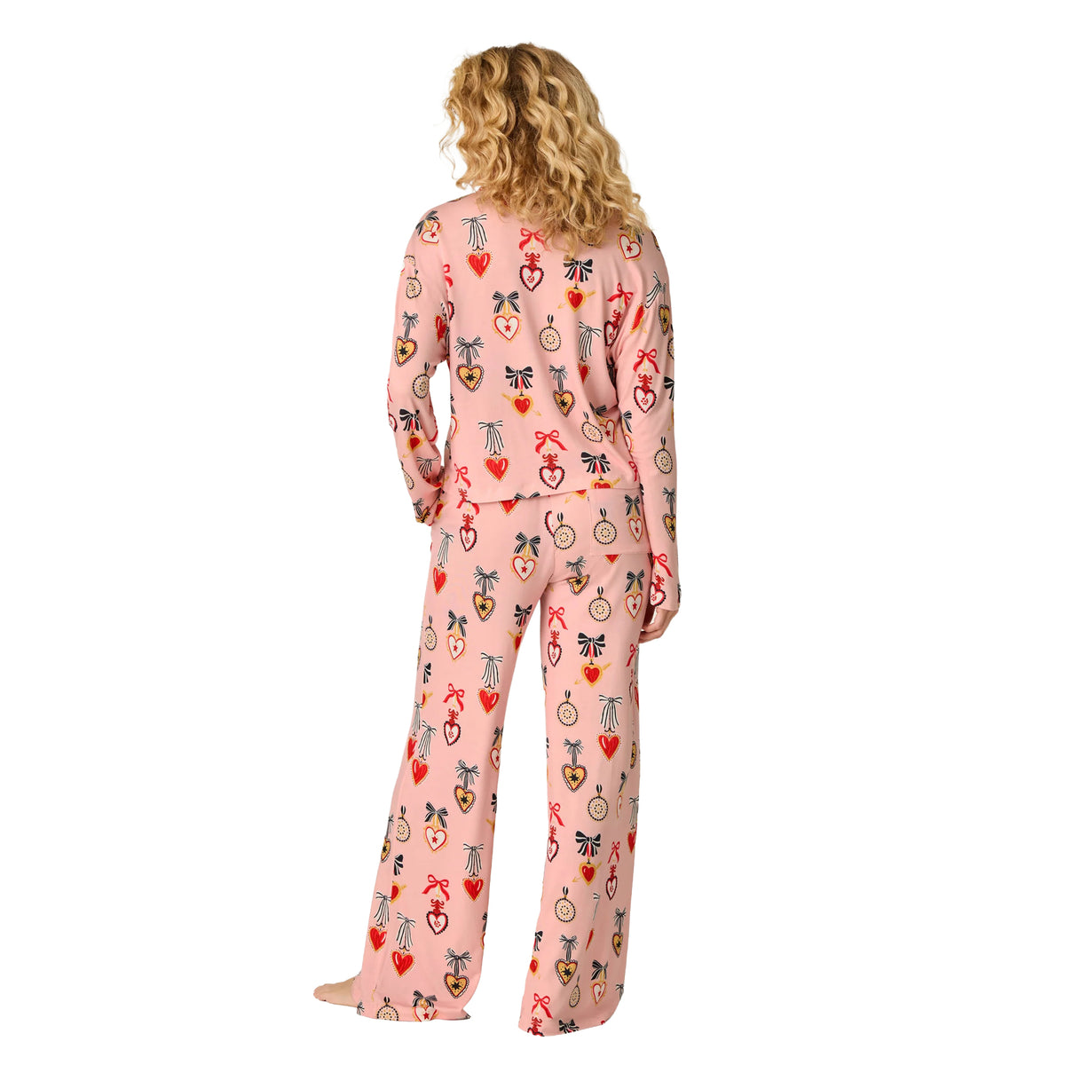 Model wearing PJ Salvage Hearts modal pyjama set in iced rose pink with relaxed long-sleeve top and wide-leg pants, back view.