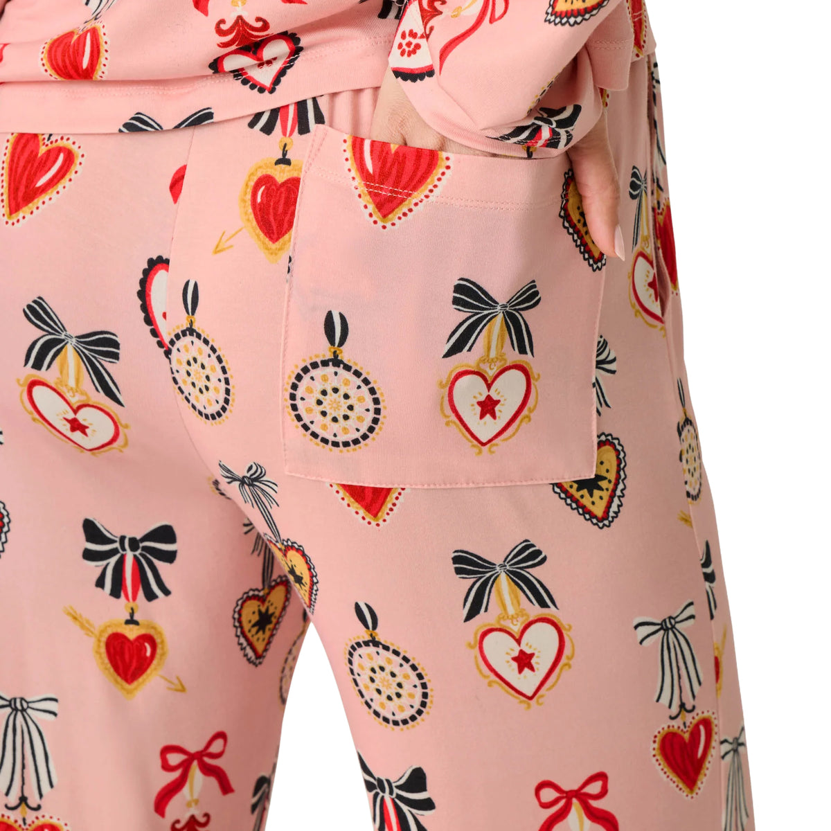 Close-up of PJ Salvage Hearts modal pyjama pants featuring a side pocket and decorative heart and bow print in iced rose pink.
