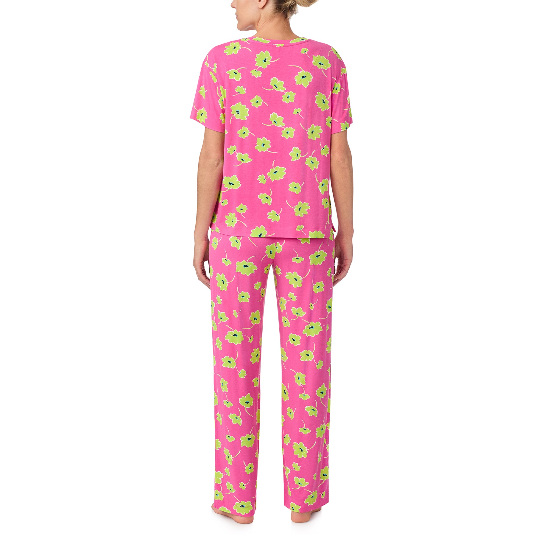 sanctuary short sleeve top and pants set in lime green poppy flower print on a hot pink background. Rear view on model.