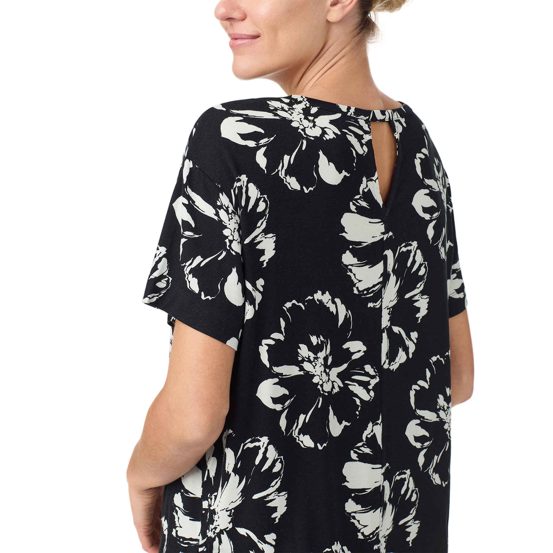 sanctuary short sleeve top and shorts set in brushstrokes print with white flowers on a black background. Rear view close up on model.