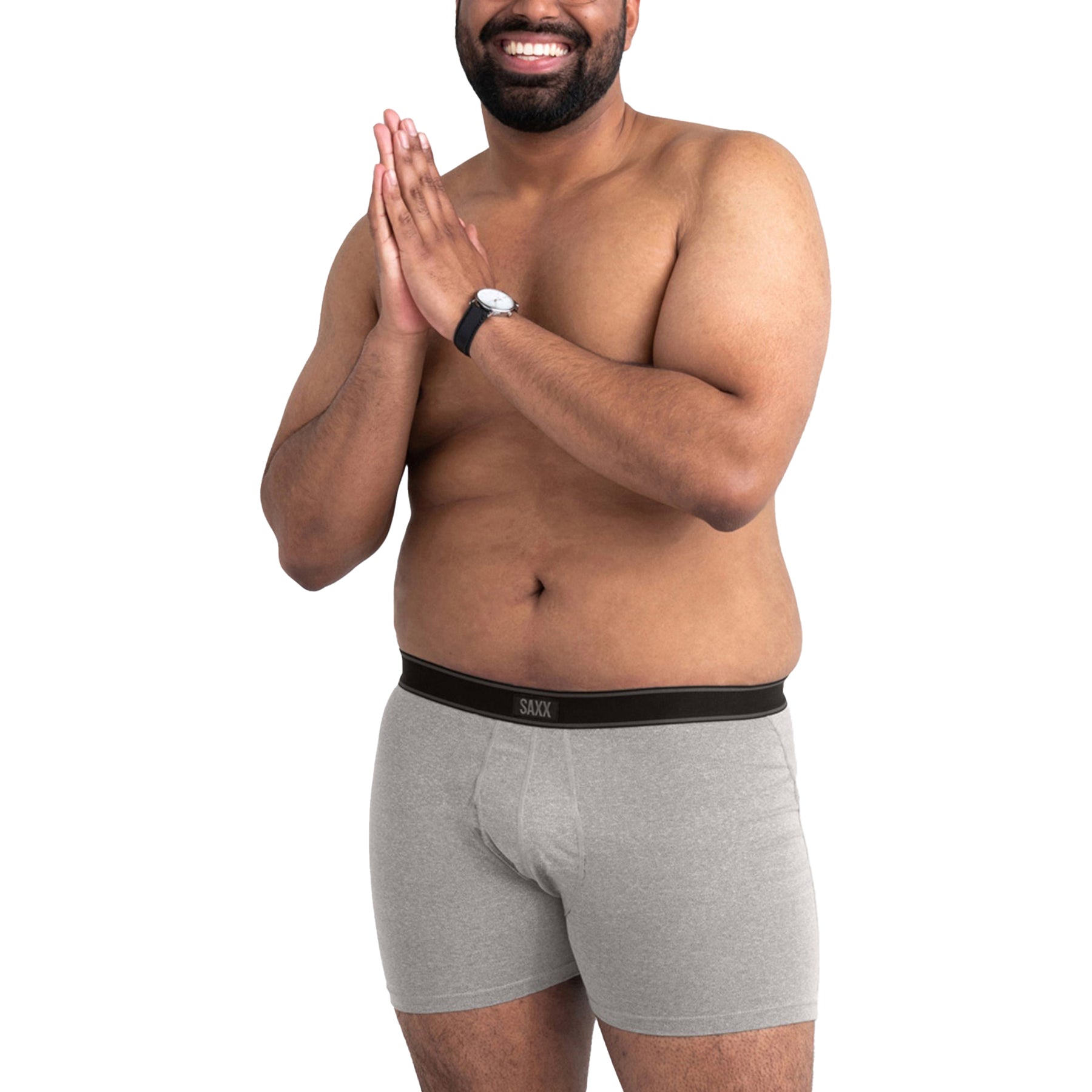 Front view of smiling model in SAXX Daytripper heather grey boxer briefs - mid-rise with supportive fit and relaxed silhouette.