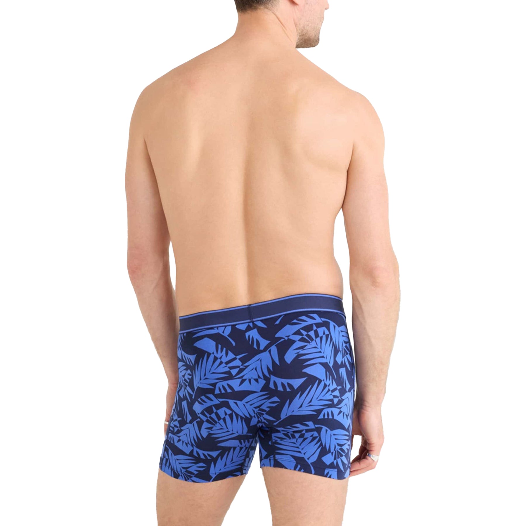 Model back view wearing SAXX Daytripper Boxer Brief in blue palm leaf pattern - relaxed fit.