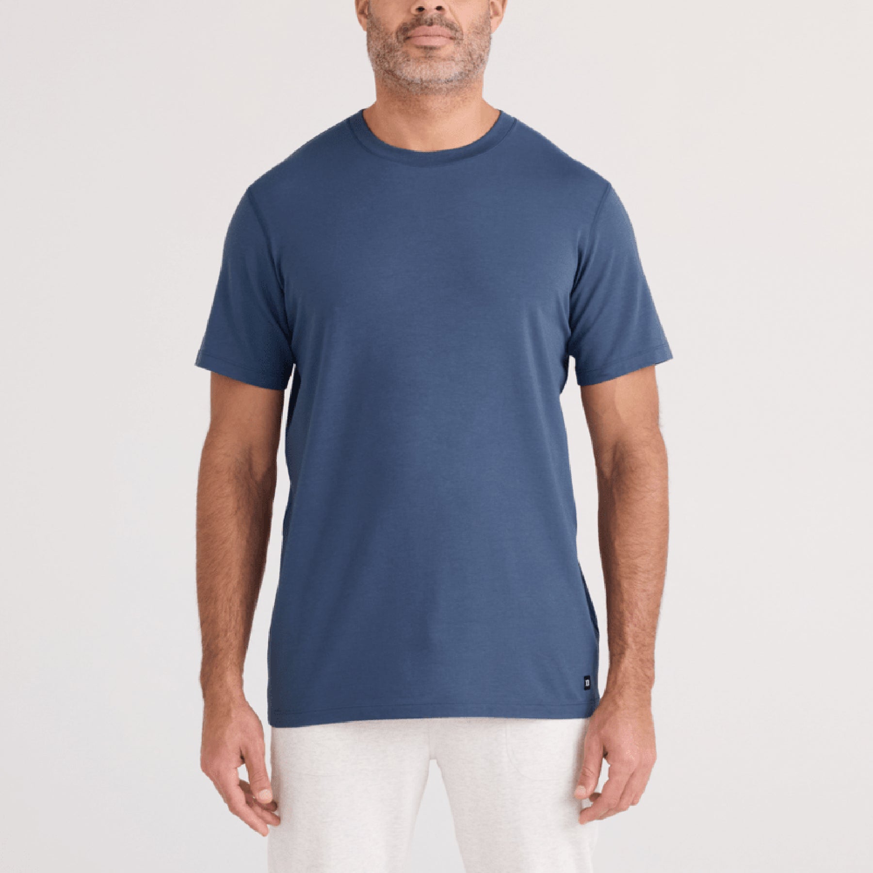 SAXX SXTS82 Short Sleeve Drop Temp Cooling TShirt in washed indigo blue. Front view on model.