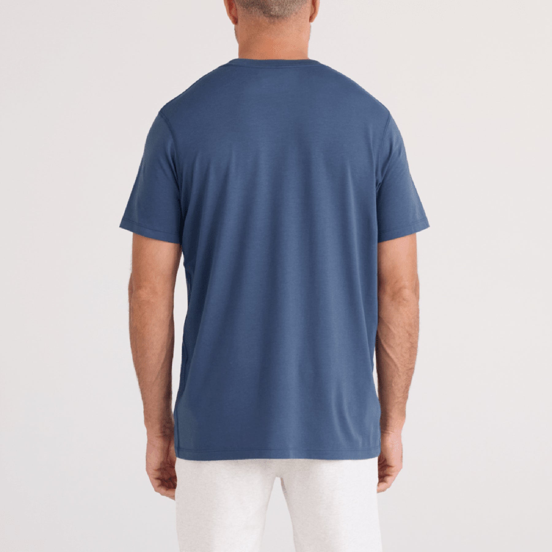 SAXX SXTS82 Short Sleeve Drop Temp Cooling TShirt in washed indigo blue. Rear view on model.