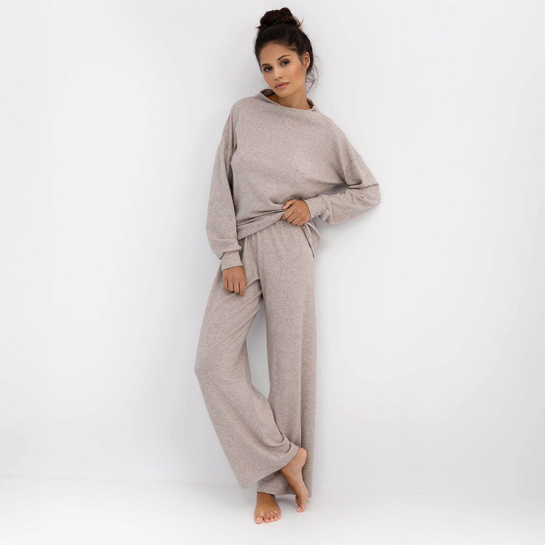 Model wearing Sensis Zayla taupe heather lounge set with long sleeve top and wide-leg pants – standing pose