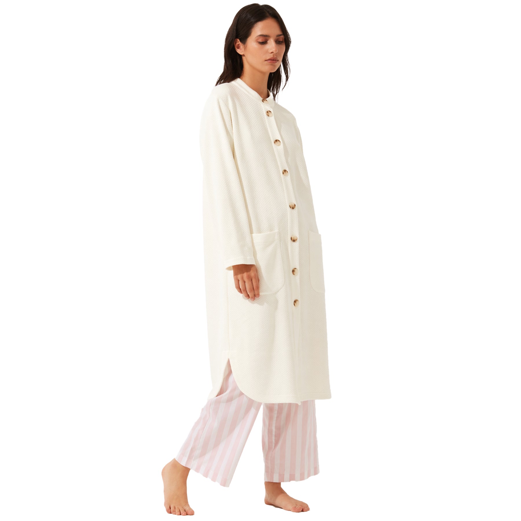 Ivory long button-front robe with patch pockets, worn over pink striped pajama pants, relaxed fit on model