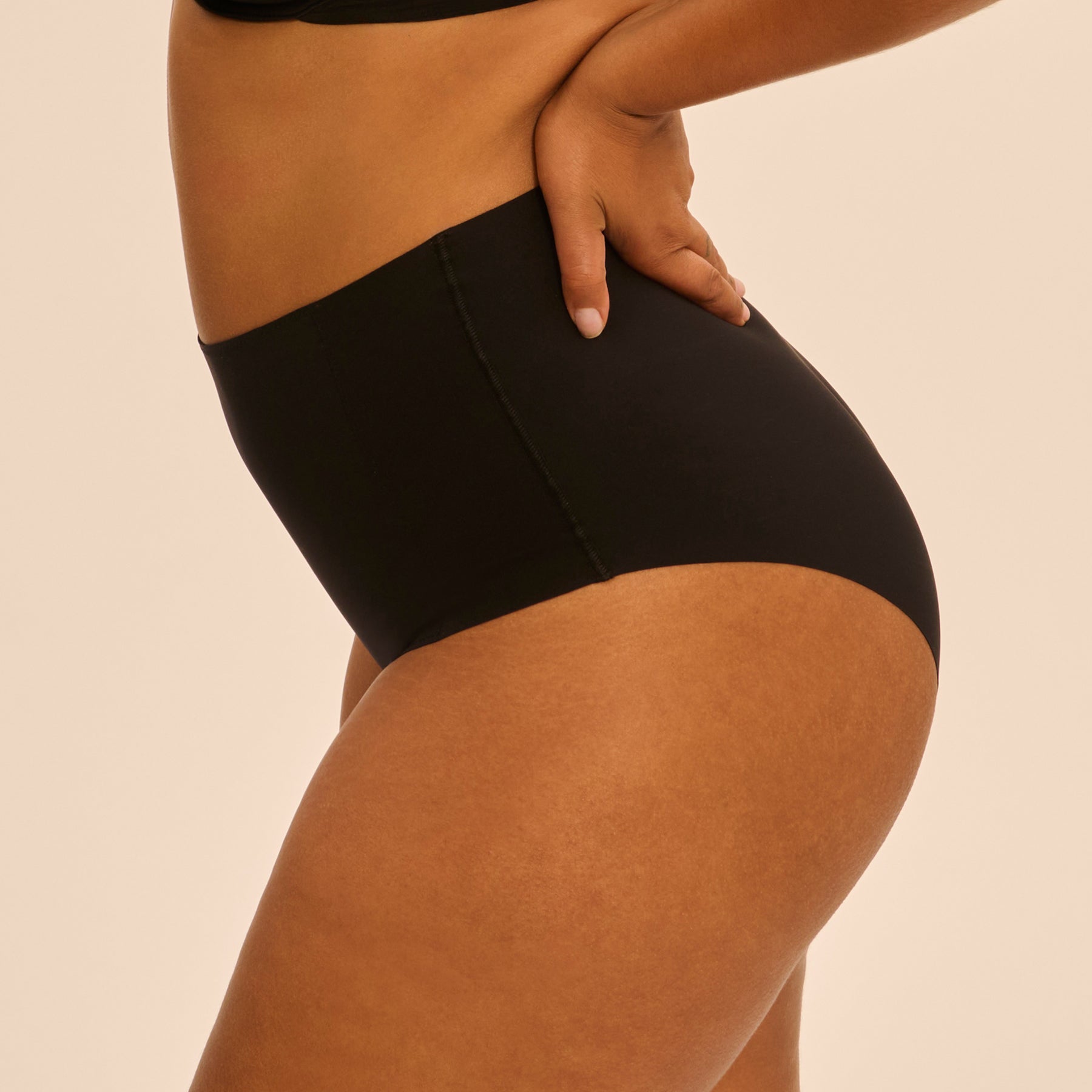 Side view of Simone Perele Story Control Full Brief in Black - seamless shaping fit with flattering coverage