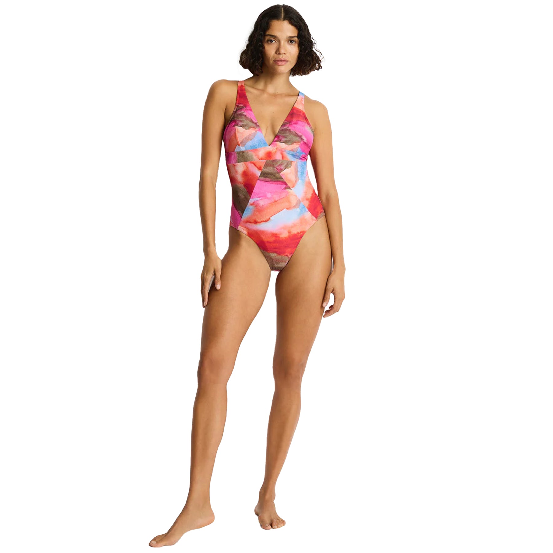 Full body front view of pink watercolor one-piece swimsuit with deep V neckline and cross-front detail on model