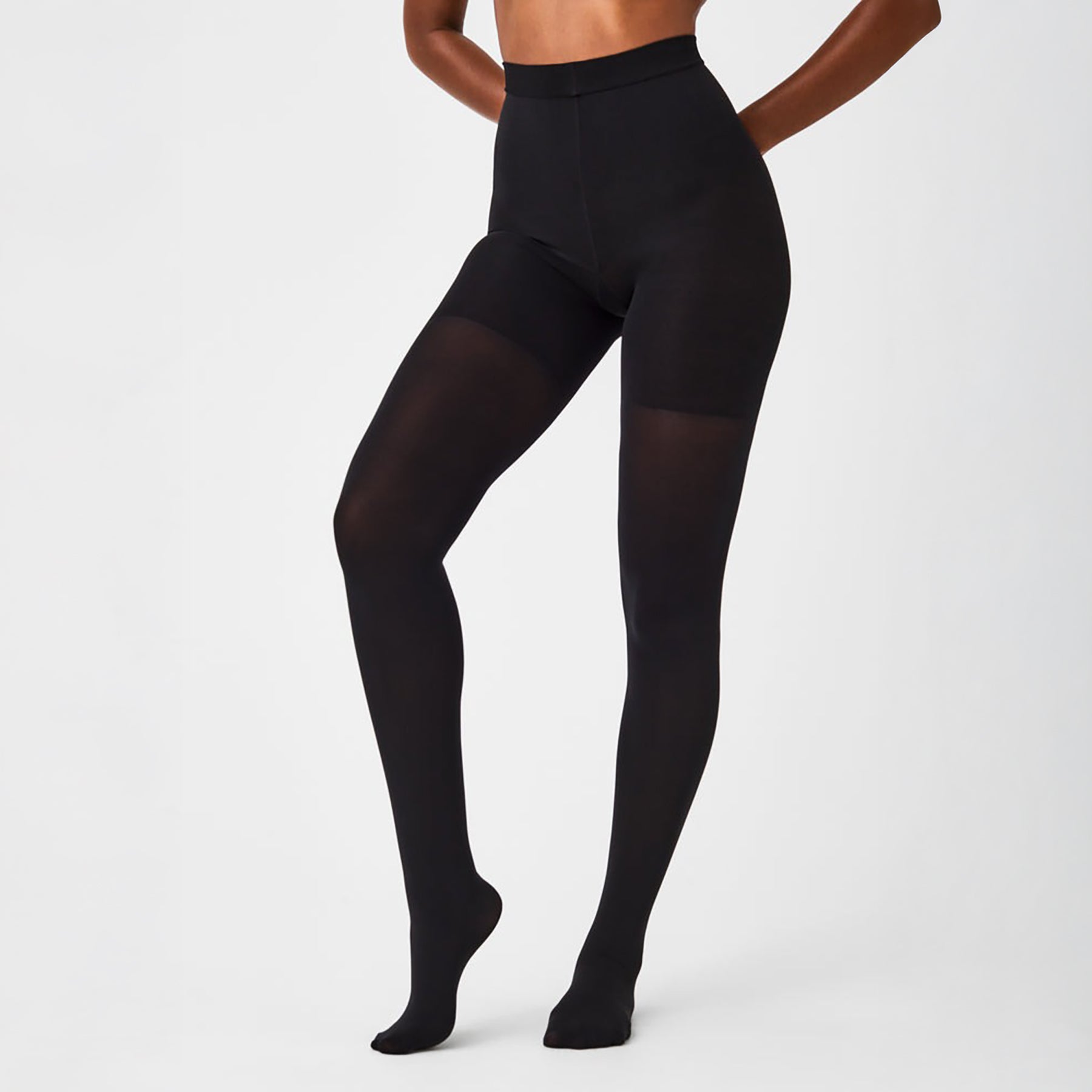 Front view of SPANX Tight-End Control Tights in Very Black, featuring mid-thigh shaping and a smooth high waistband.