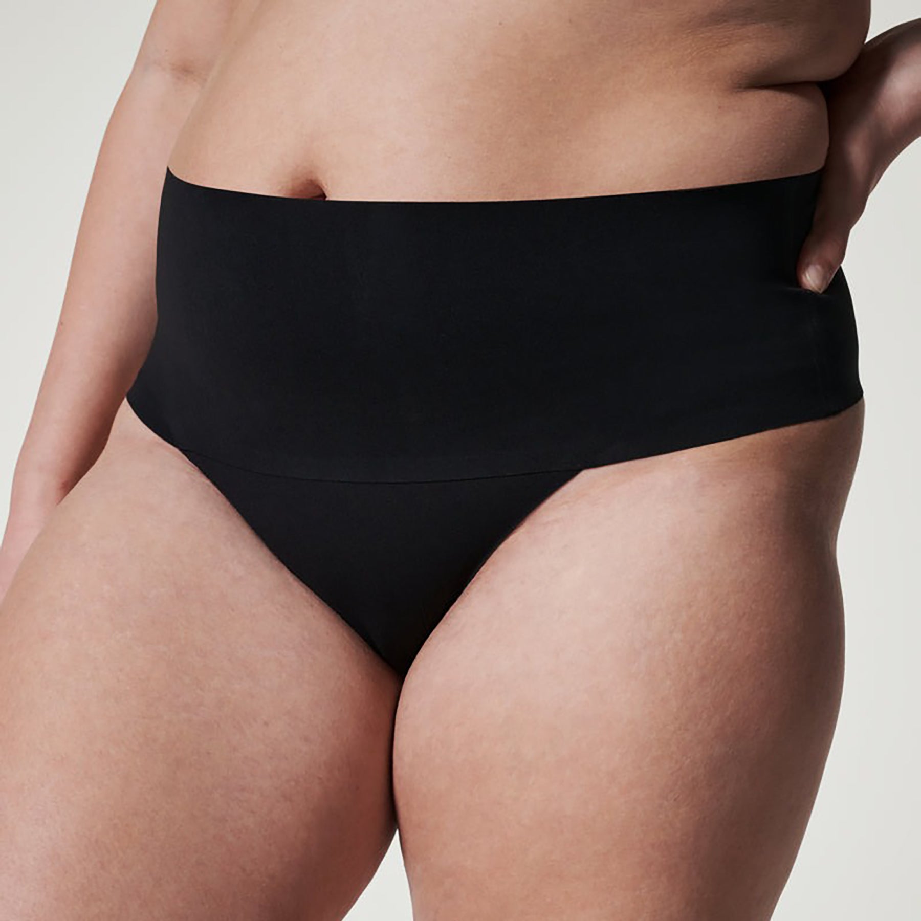 Close-up detail of SPANX Very Black seamless thong showing soft, stretchy fabric for smoothing and all-day comfort.