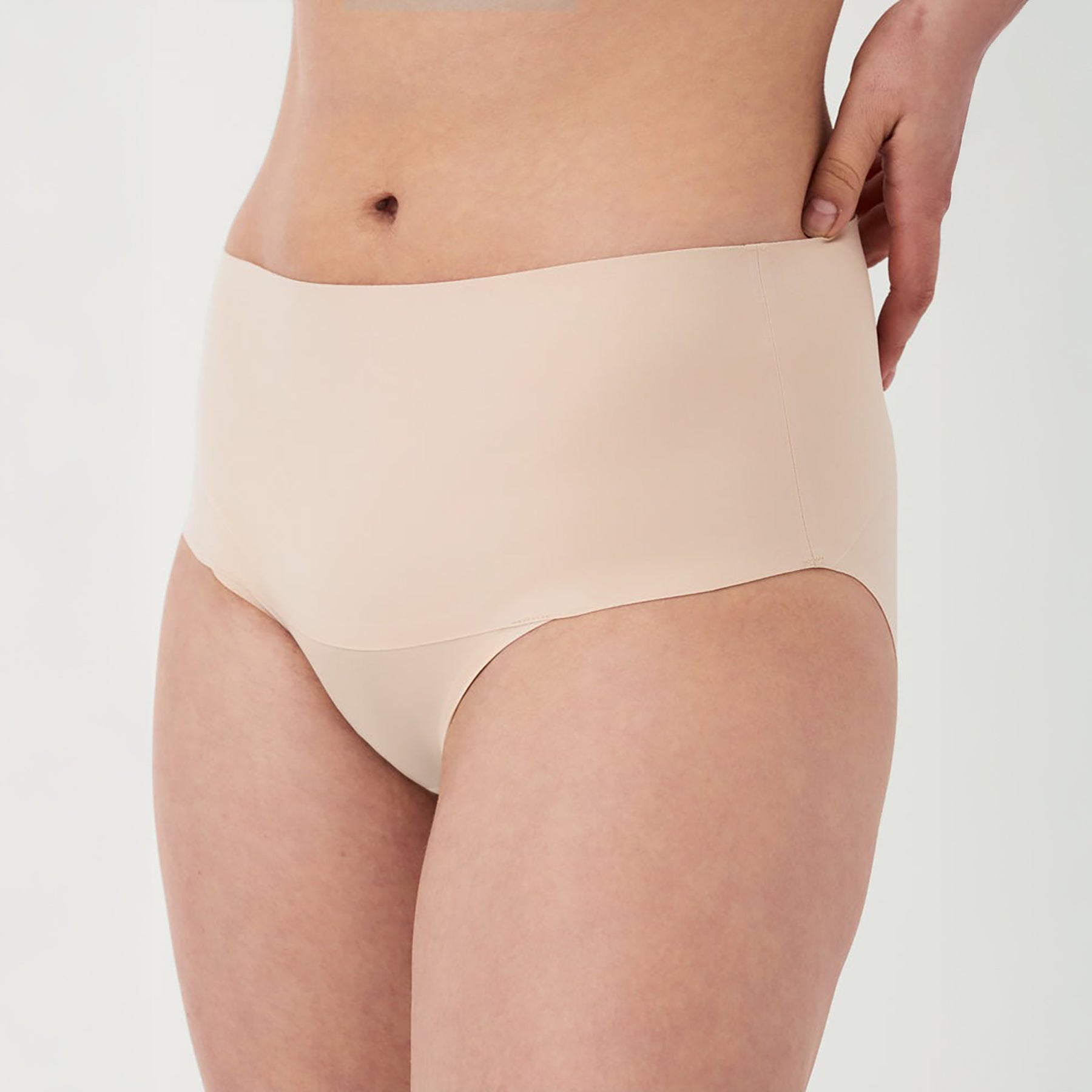 Front view of SPANX High-Waist Control Seamless Brief in Soft Nude, featuring smooth shaping fabric and invisible edges for a seamless look under clothing.
