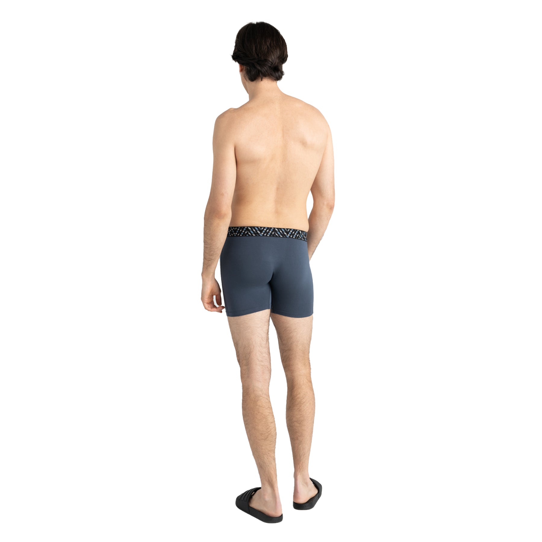 Man wearing dark gray swim shorts on a white background