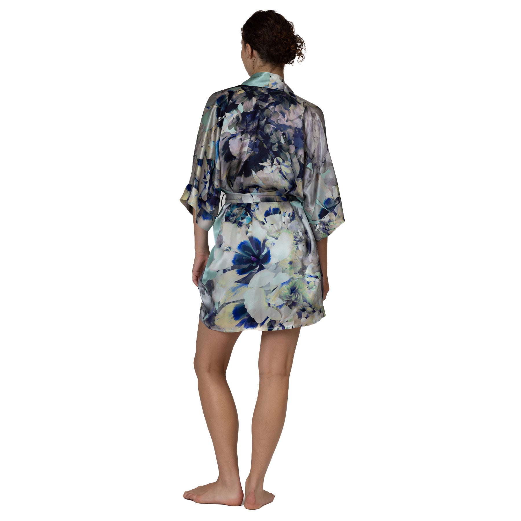 Back view of a short floral satin robe with an oversized artistic flower print and adjustable self-tie waist.