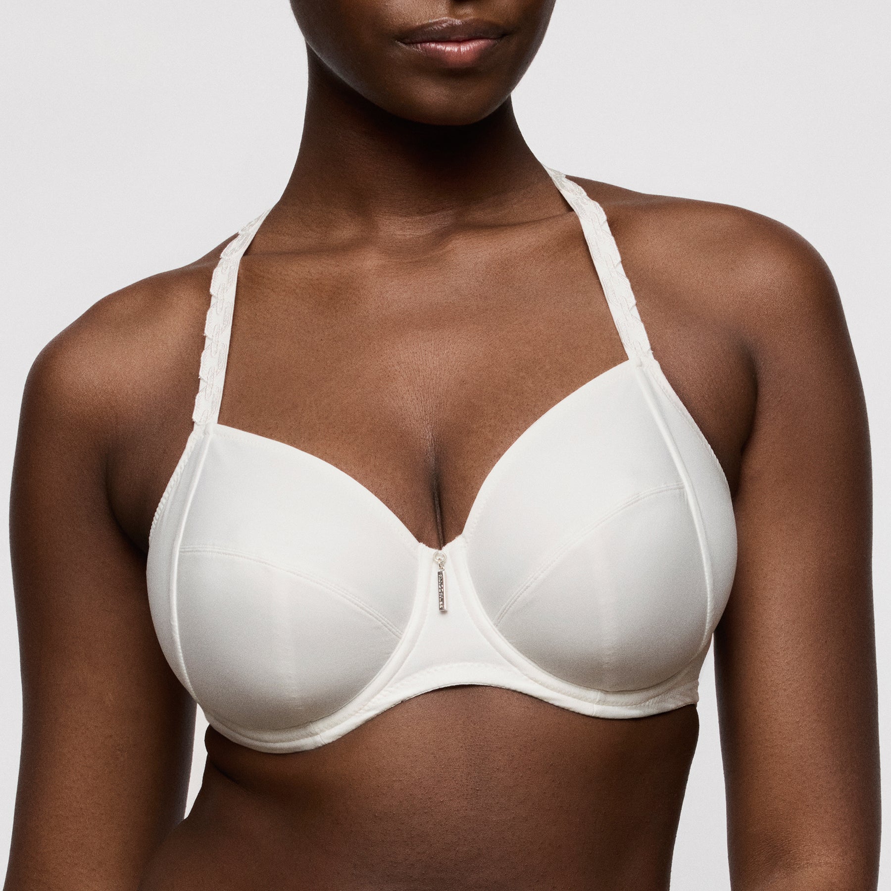 Primadonna twist twixie full cup bra 0142530 in natural ivory. Front view close up on model with straps worn racerback.