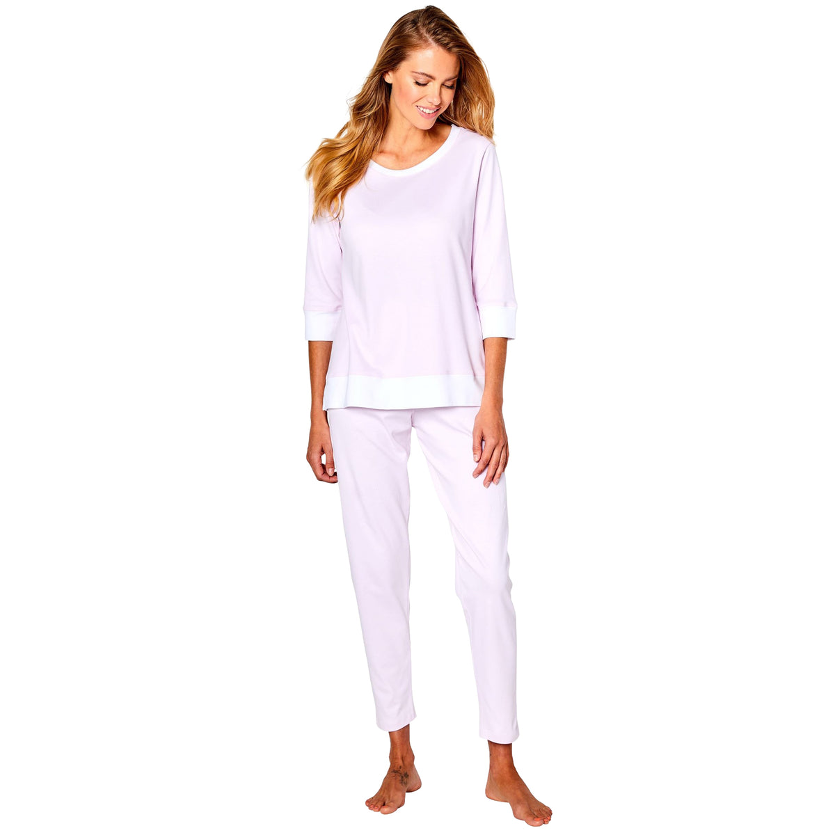 Model wearing Marchelle Marelle pyjama set in soft pink with white trim, three-quarter sleeve top and matching ankle-length pants, front view.