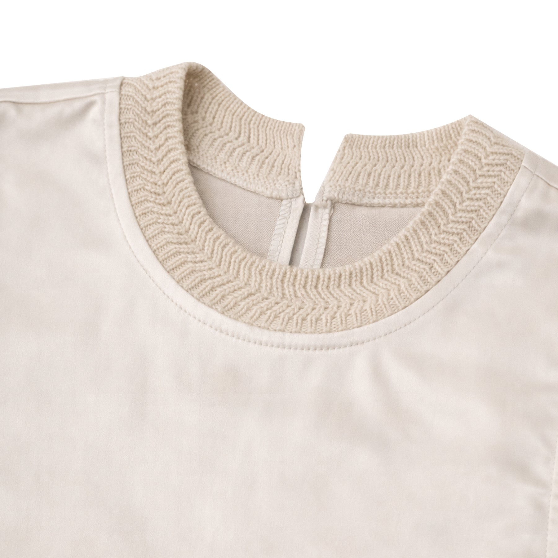 Close-up of off-white satin blouse highlighting the textured knit collar, soft sheen fabric, and back zipper detail.