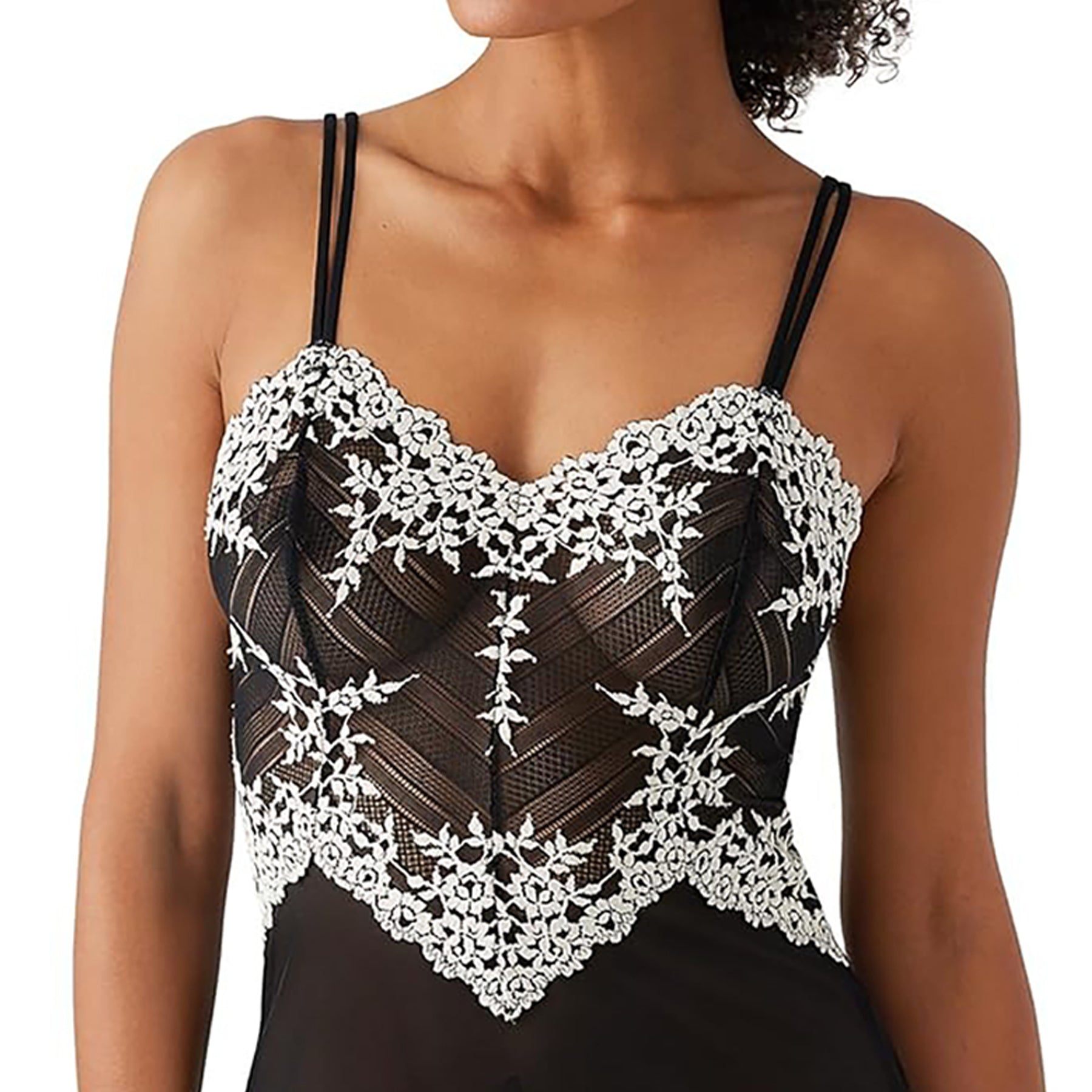 Spaghetti strap sheer black mesh chemise with cream lace embroidery details on model front view closeup