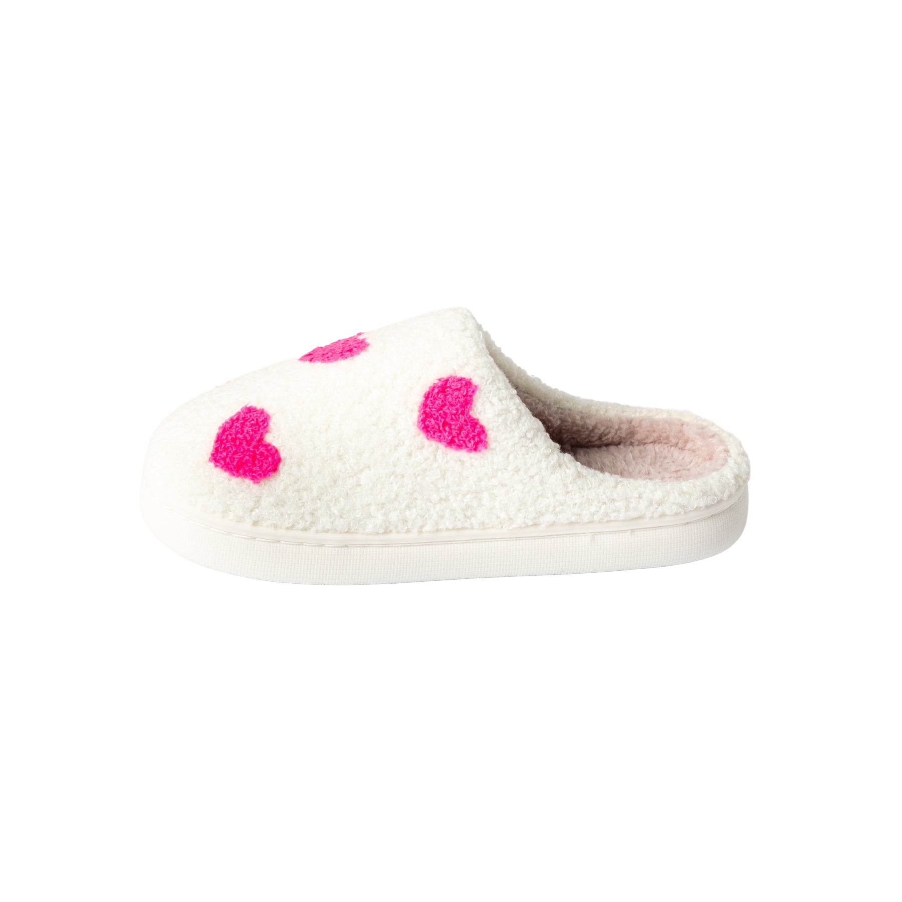Angled view of a women's cream fuzzy mule slipper featuring vibrant pink hearts, soft plush interior, and lightweight white outsole.