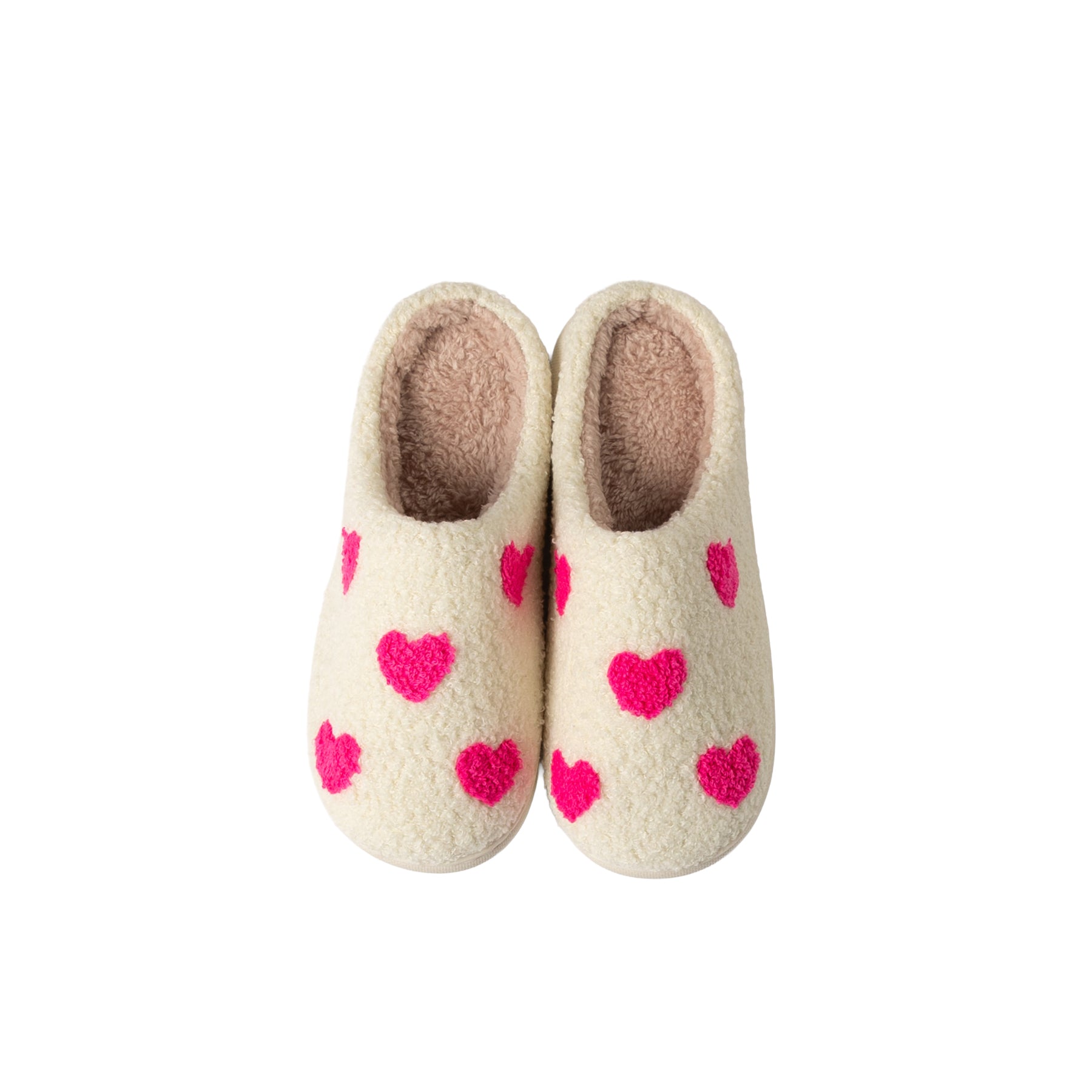 Side view of a women's cream sherpa mule slipper with bright pink heart pattern, plush lining, and cushioned white sole.