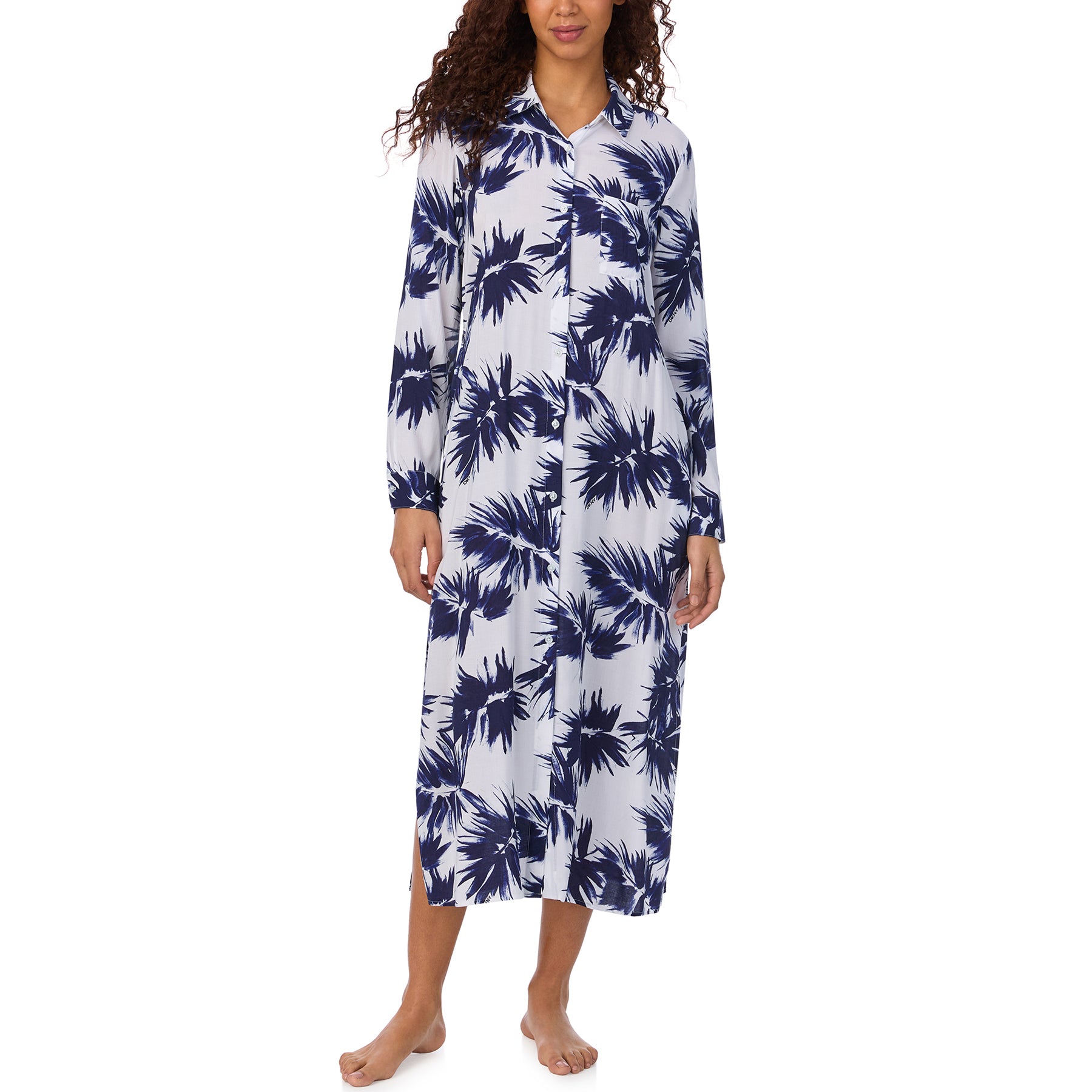 Model in a relaxed-fit long shirt dress with navy palm-leaf print and long sleeves, unbelted.