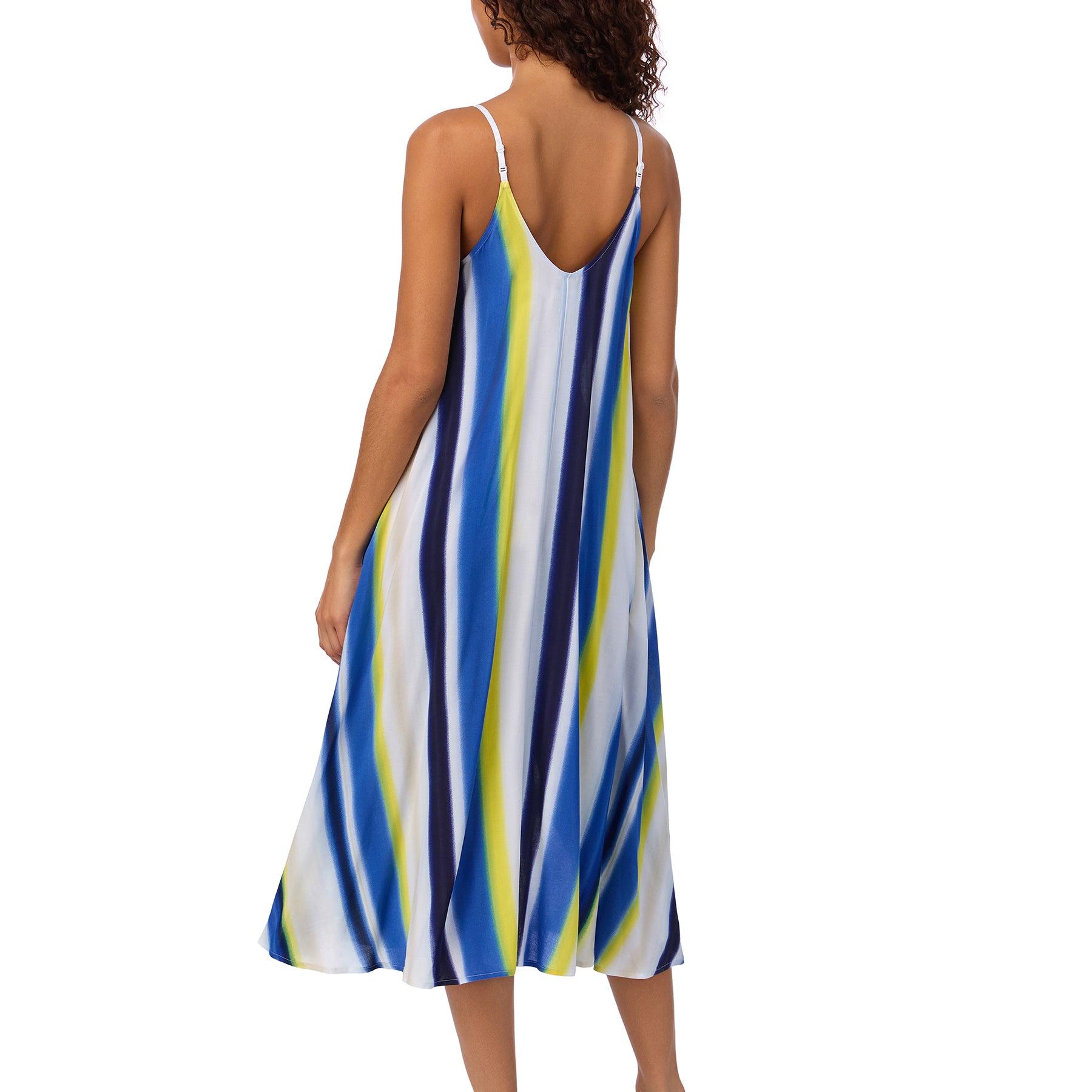 Model wearing a sleeveless midi dress with bold blue, navy, lime, and white diagonal stripes and braided straps.