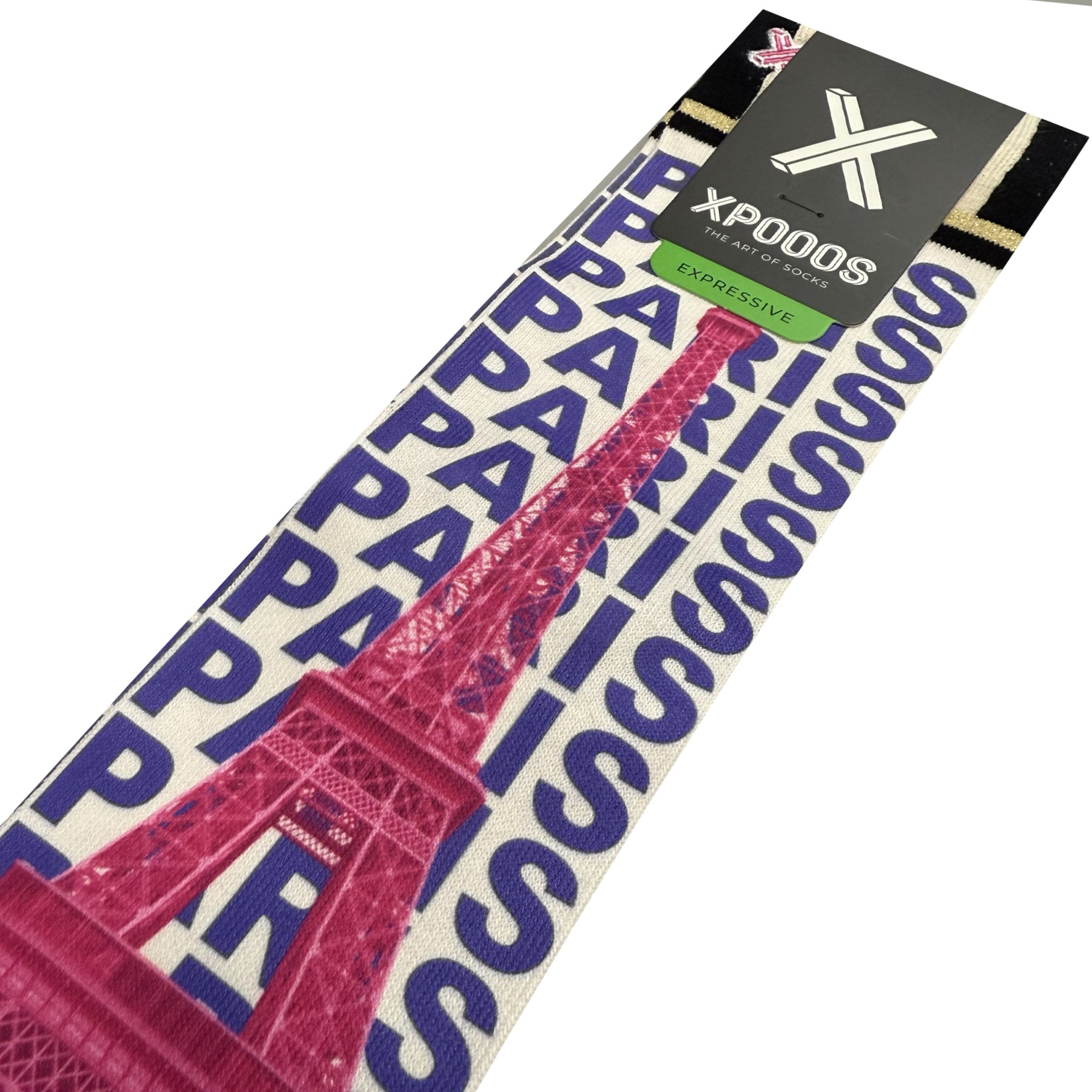 Close-up angled view of XPOOOS Paris crew socks with vibrant pink Eiffel Tower print layered over repeated blue Paris lettering on white background.