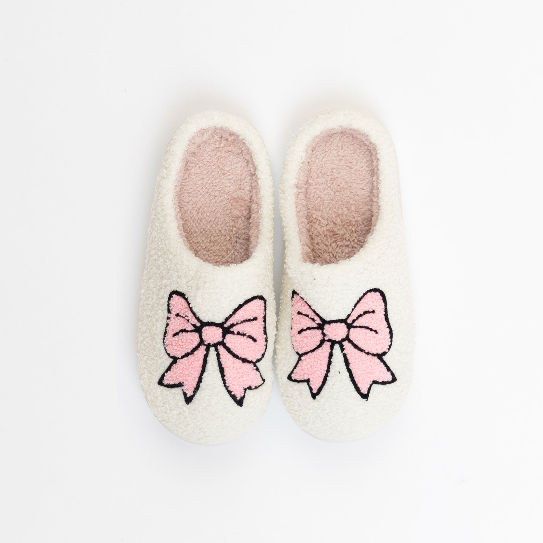 Soft cream women’s slippers with pink bow design on the front.