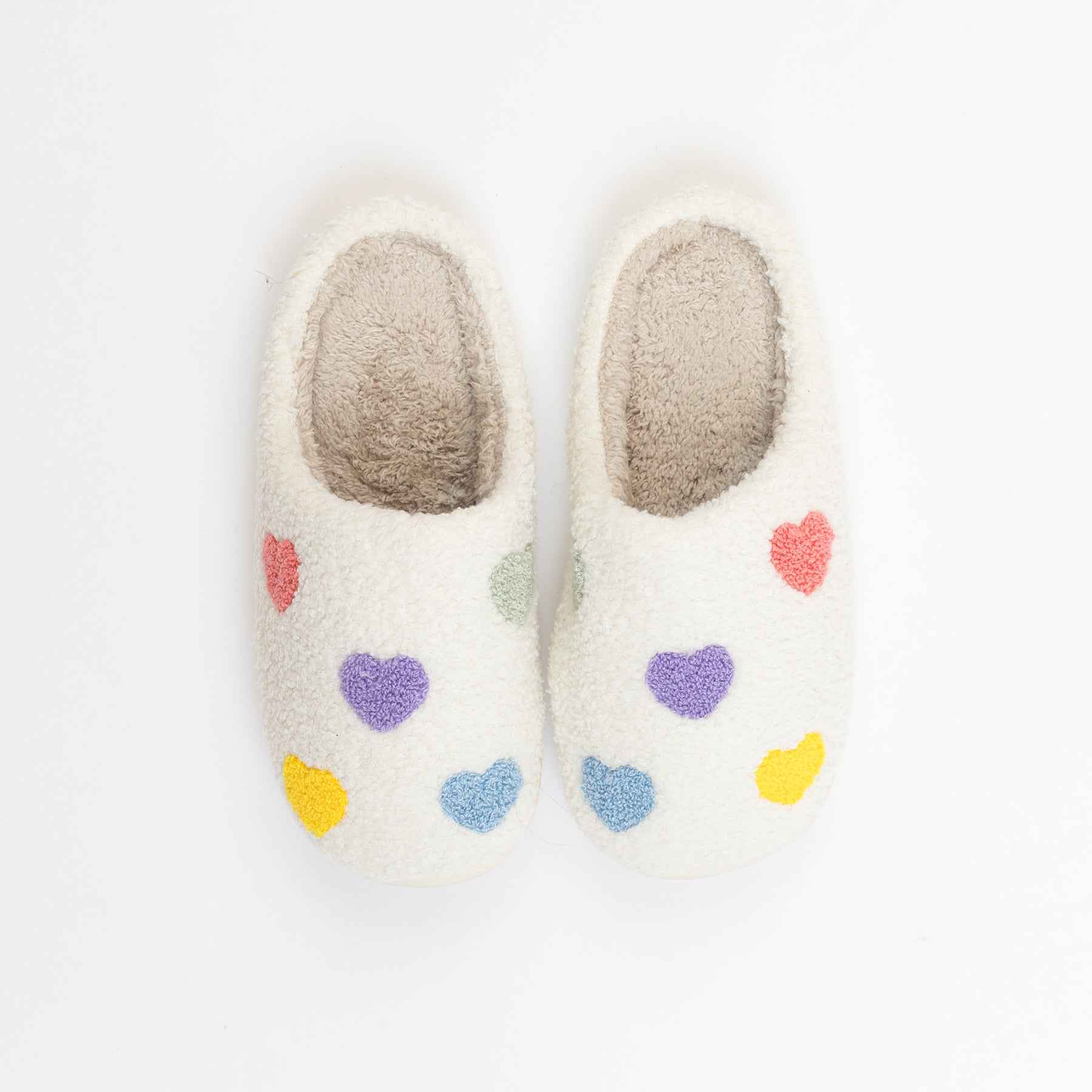 Fluffy cream women’s slippers with colourful heart print design.